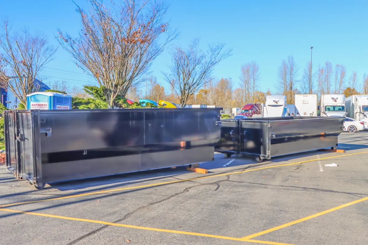 Professional dumpster rental service with roll-off container on residential driveway in Maplewood